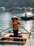 Boats in Ha Long Bay, Vietnam - a floating village is in the background