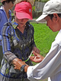 Janet - crafts lesson using a large palm tree leaf - on an island near My Tho in the Mekong Delta, Vietnam