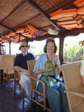 Judy drinking coconut milk from a coconut after a bike ride on an island near My Tho in the Mekong Delta, Vietnam