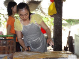 Making coconut candy - this worker cuts coconut candy 8 hours a day - on an island near My Tho in the Mekong Delta, Vietnam 