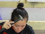 An artisan preparing an item for sale at the stores located at our unscheduled shopping stop - Siem Reap Province, Camodia