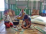Two children and a man weaving water hyacinths for baskets & place mats sold at a floating gift shop we visited - Tonle Sap Lake