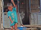 A boy fishing from his floating house - Tonle Sap Lake, Siem Reap Province, Cambodia
