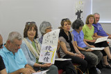 Judy displaying a calligraphy painting of her fortune based on her name -  created by Masunaga Koshun 