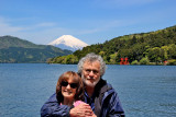 Judy and Richard at the Moto-Hakone port with Mt. Fuji, the red torii (gate) of the Hakone Shrine & Lake Ashi in the background