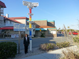 Judy next to the Hurricane Storm Surge Elevation sign near the beach on the East Coast of Tybee Island