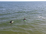 Two surfers (in mid-February) as seen from the fishing pier on the East Coast of Tybee Island