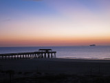 Dawn - Fishing pier and cargo ship - East Coast of Tybee Island