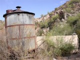 Water storage..concrete tank in back. Complete with solar panel-pump!