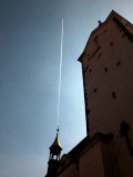 A rocket  risisng from a church steeple (or maybe a jet contrail in just the right position :)