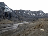 The black snow covered mountains that you see, is actually the face of the glacier that was covered in volcanic ash