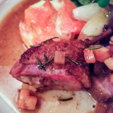 Braised leg and roasted breast of Liberty duck with quince and saffron, roasted new onions, and butternut squash gratin