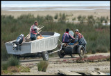 Fishermen towing their boat down to Caspian Sea the easy way - with a motorbike!