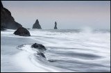 Stormwaves from south-east at Reynisdrangar near Vik with sand drift  over the ocean