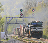 The morning fog still clings to the hillside as Northbound 116 comes under the signal bridge at Geneva