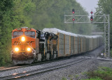 BNSF, NS and UP power bring I-39 by the East end of the siding at Waddy