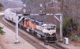 A Southbound grain train comes under the signals at Revilo KY with a set of BNSF power on a cloudy day