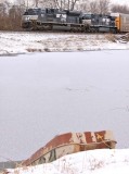NS 1027 leads train 23G along the shore of a frozen Lake Wells as a sad little John Boat is slowly consumed  by the ice 