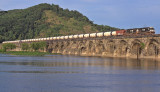 Symmetric The low evening sun lights up the weather beaten arches of Rockville bridge as an empty unit oil train crosses 