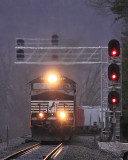 The weather has turned dark and moody as M77 comes by the new signals at SouthFork 