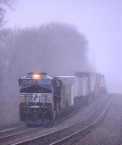 The hot 229 sits in a sleet storm at Gradison, waiting on a pair of Northbounds to clear before running around a train ahead 