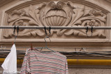 Moulded plaster lintels, Thirties style, now crowded out with cables, wires and washing hung out to dry