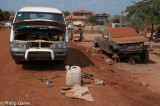 Cambodia: Roadside garage - mechanics work in the dust. 