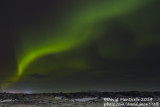 Northern lights (Aurora borealis) on partly cloudy skies_Sandvik (Iceland)
