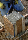 FRESHLY POURED CONCRETE IN ONE OF THE FOOTING MOLDS