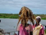 Woman carrying dried, braided  fish at Bor Harbor, South Sudan