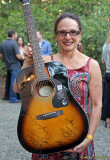 KZFR volunteer Debbe shows off the guitar for raffle