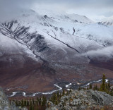 Cliff top view of snow dusted Endicott Mountains Alaska with Wiseman Creek valley