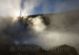 Sun beams in steam rising off of the Chena Hot Springs Alaska in Fall