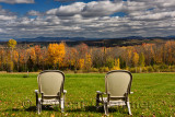 Two lawn chairs at Green Bay Loop overlooking Peacham and Barnet hills Vermont with Fall colors