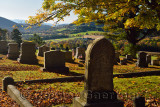 Gold maple leaves and American flags at Peacham Corner Cemetery Vermont in the Fall