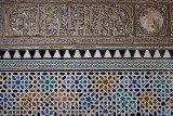 Close up of arabic wall carving and tiles at Alcazar palace Seville Andalusia
