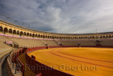 Golden sand and empty stands at Seville bullfighting ring