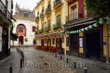 Narrow wet cobblestone Argote de Molina street ending at the north side of the Seville Cathedral