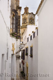 Gold and white buildings on Maldonado street with Saint Peter belfry in Arcos de la Frontera Spain