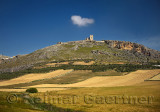 Ruins of Estrella Castle on hilltop above Teba Malaga Spain with farm fields