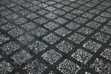 Light and black grid of river pebbles on Oficios street at the Royal Chapel Granada Spain