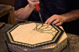 Craftsman working on inlaid platter in a Alhambra shop Granada