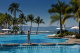Retired woman on stepping stones of pool at Nuevo Vallarta on Pacific Ocean Mexico