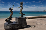 Triton wth broken arm and Mermaid bronze statues on the Malecon of Puerto Vallarta Mexico