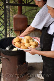 Women cooks making Baursaks in an outdoor kazan at Kazakh ethnic village near Almaty Kazakhstan