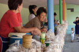 Women selling kumis horse milk and kurt cheese balls at road side stand near Altyn Emel Park Kazakhstan
