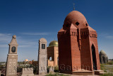 Brick mausoleums granite headstones at Roadside Muslim cemetery near Shelek Kazakhstan