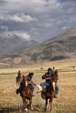 Horse rider trying to steal goat carcass in game of Kokpar Tudabarai in Aksu Zhabagly Kazakhstan