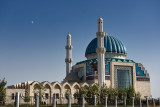 Modern white and blue Hoca Ahmet Yesevi Mosque with moon Turkistan Kazakhstan