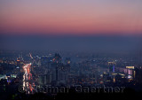 Red glow after sunset over Almaty with highrise towers and Al Farabi Avenue Kazakhstan